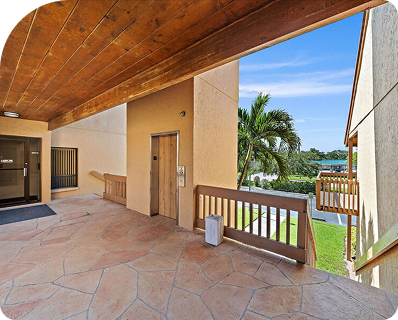 Second-floor breezeway with stained wood ceiling